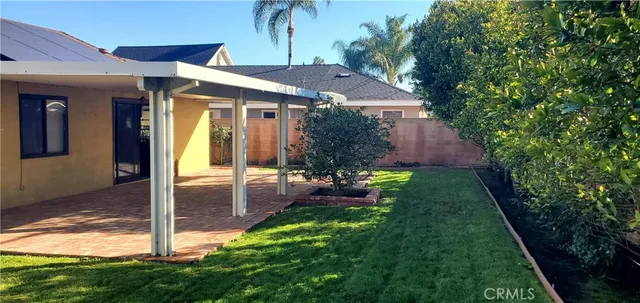 a view of a house with a yard potted plants