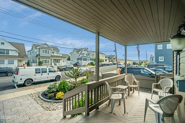 a view of a patio with couches table and chairs and potted plants
