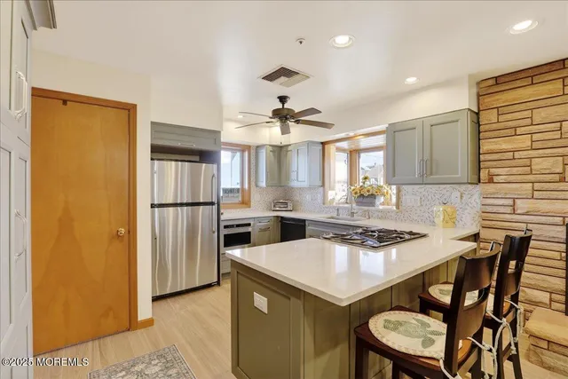 a kitchen with a table chairs refrigerator and cabinets