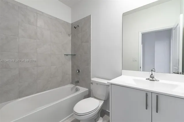 a bathroom with a sink mirror toilet and bathtub