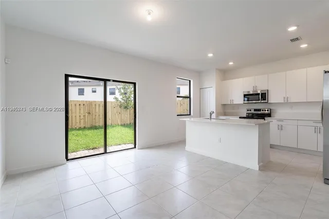 a kitchen with stainless steel appliances granite countertop a refrigerator oven a sink and dishwasher