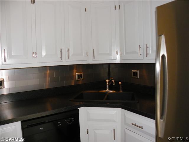 2511 Hicks Road North Chesterfield, VA 23235 - Photo 7 of 11 a kitchen with granite countertop white cabinets and black appliances