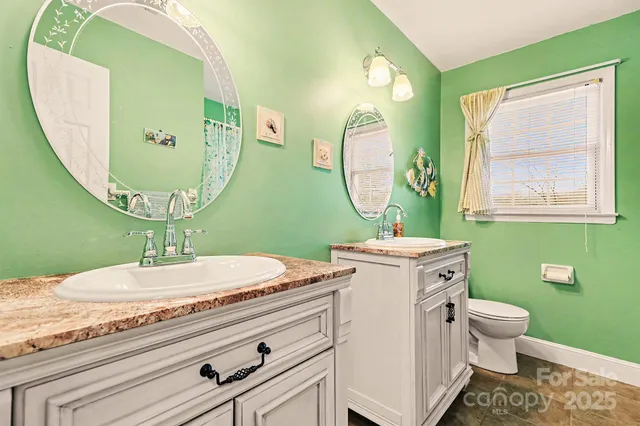 a bedroom with a bed lamp and a large window