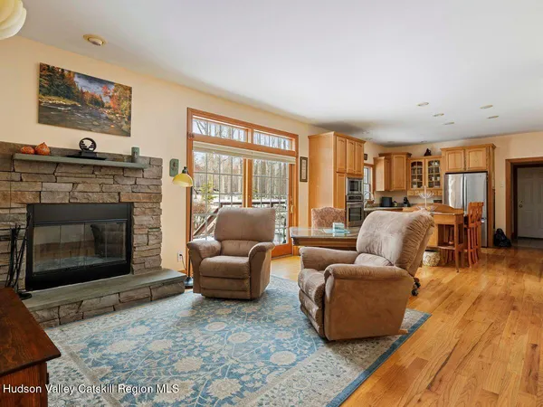 a bedroom with a bed and large windows