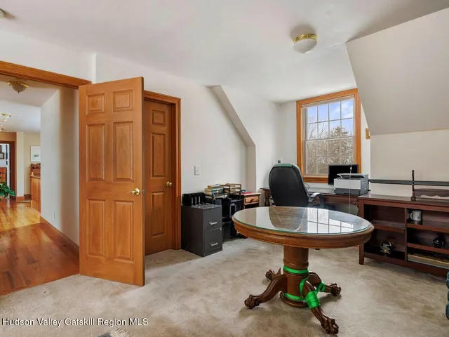 a view of a house with a yard covered in snow