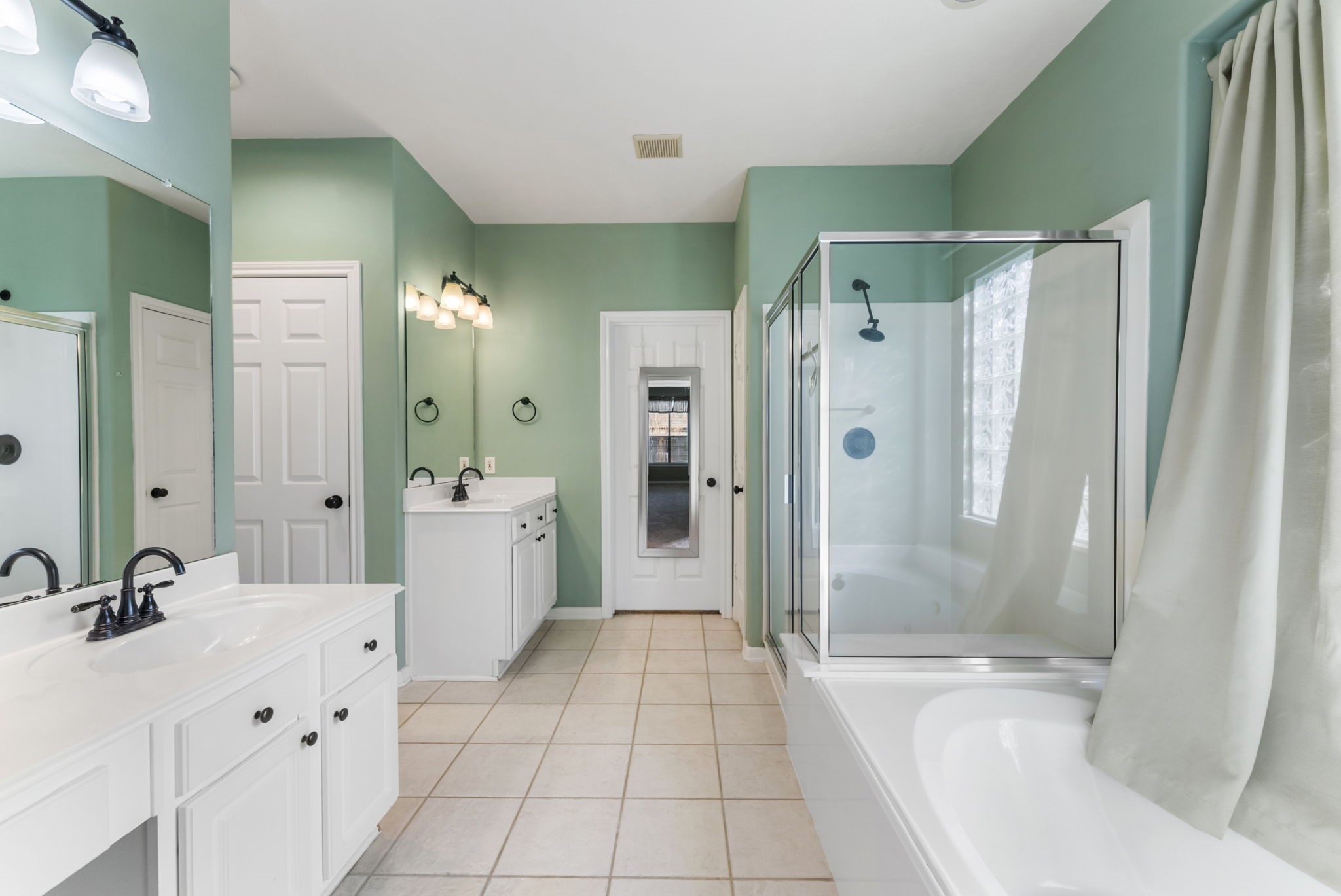 11 South Bendrook Loop Conroe, TX 77384 - Photo 13 of 27 a bathroom with a double vanity sink toilet and shower