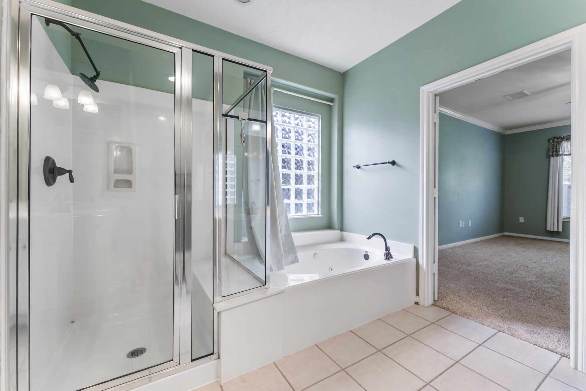 11 South Bendrook Loop Conroe, TX 77384 - Photo 14 of 27 a bathroom with a bathtub and a shower