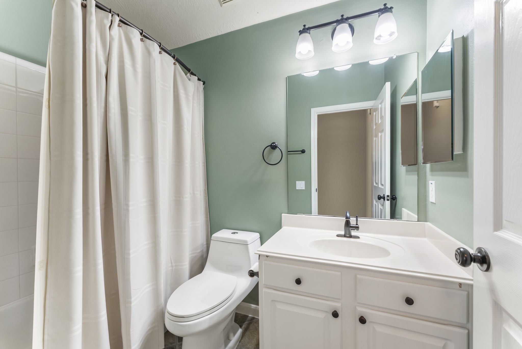11 South Bendrook Loop Conroe, TX 77384 - Photo 16 of 27 a bathroom with a sink and a mirror