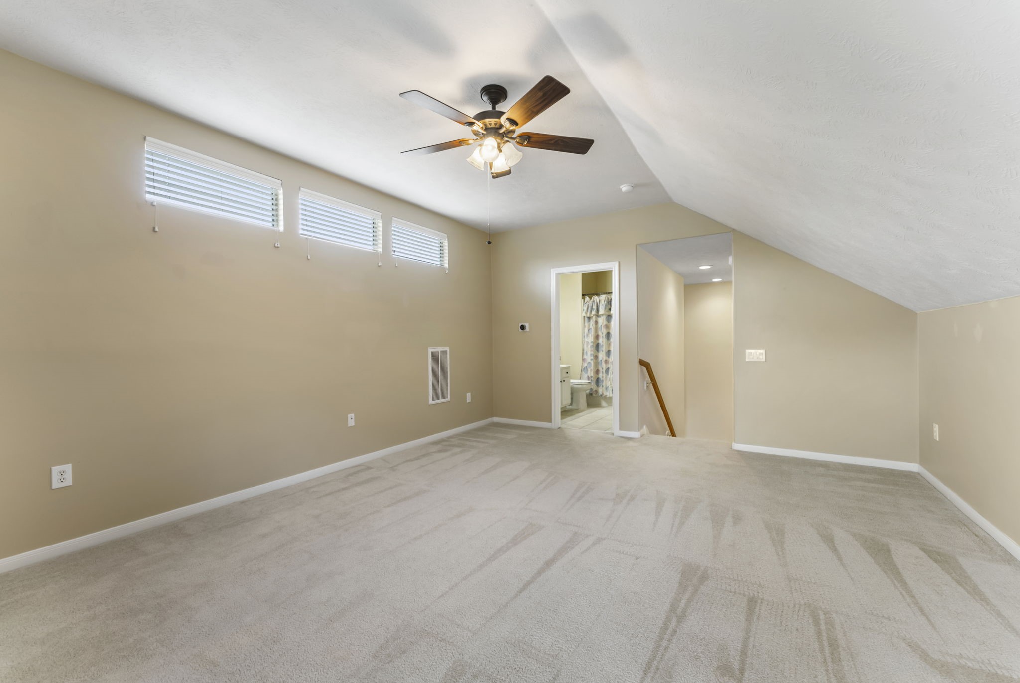 11 South Bendrook Loop Conroe, TX 77384 - Photo 17 of 27 a view of an empty room with a ceiling fan and window