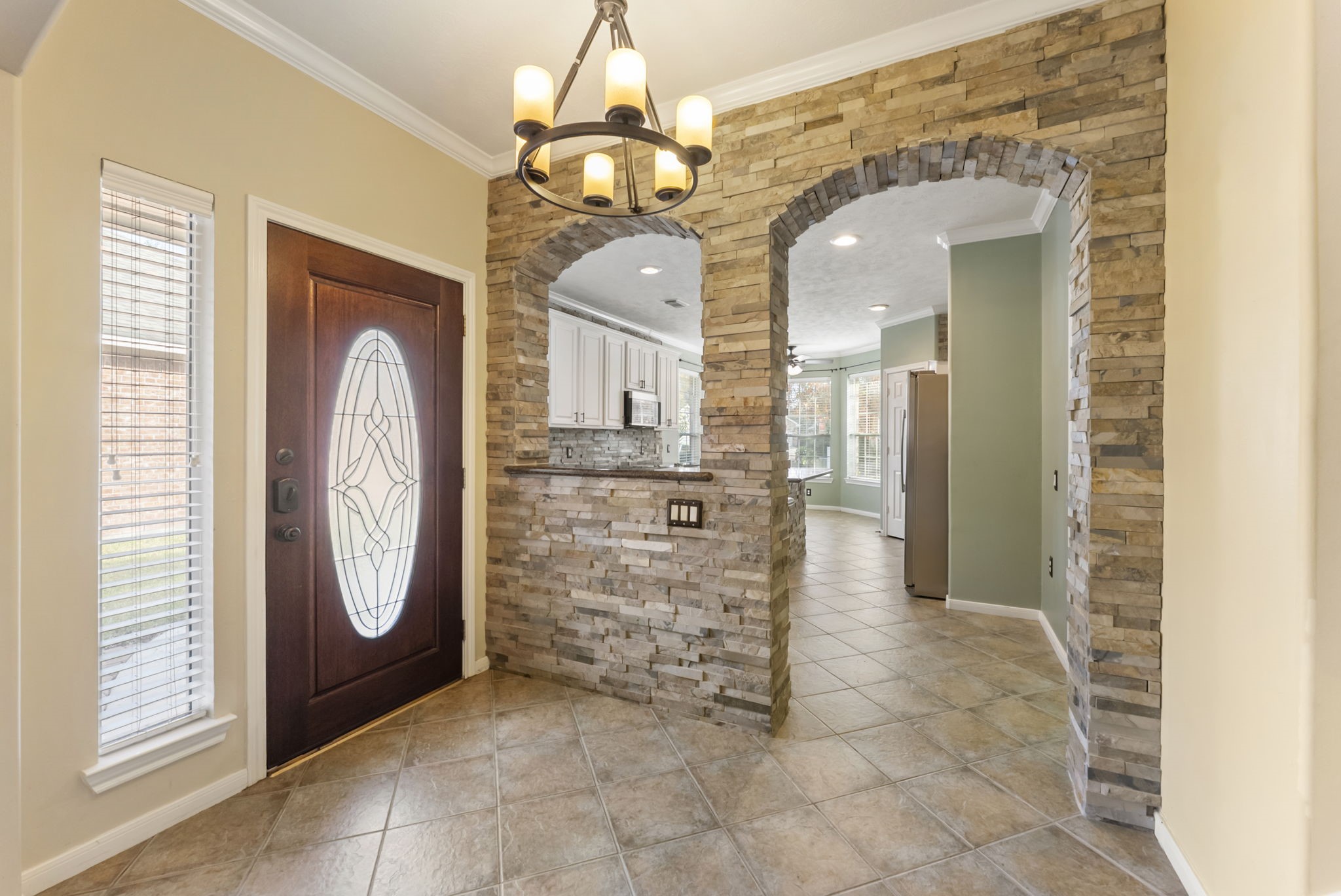 11 South Bendrook Loop Conroe, TX 77384 - Photo 2 of 27 a view of a hallway with entryway windows and chandelier