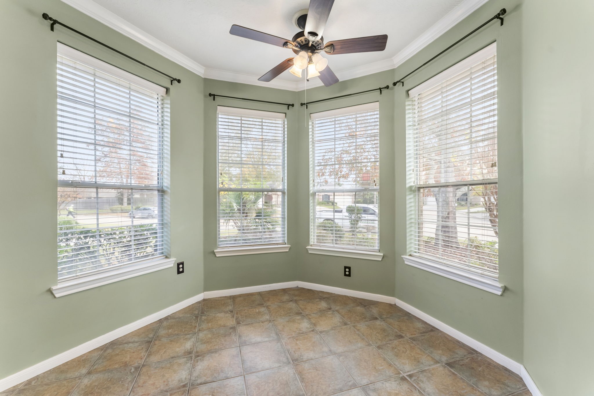 11 South Bendrook Loop Conroe, TX 77384 - Photo 6 of 27 an empty room with a window and a ceiling fan