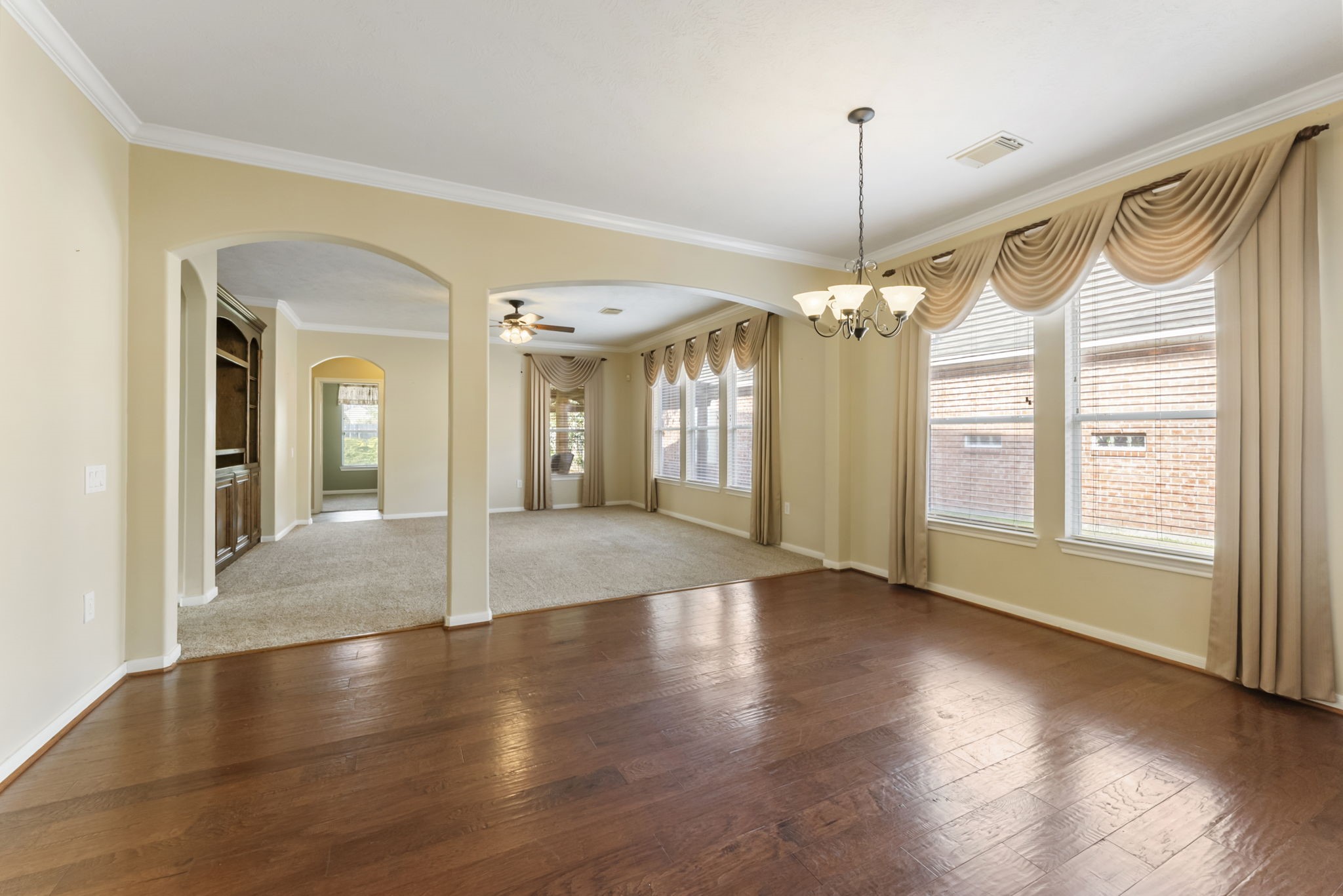 11 South Bendrook Loop Conroe, TX 77384 - Photo 10 of 27 a view of a room with window wooden floor and chandelier