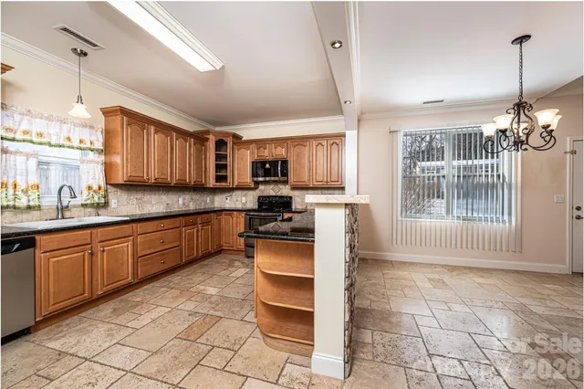 a kitchen with stainless steel appliances granite countertop a stove sink and cabinets