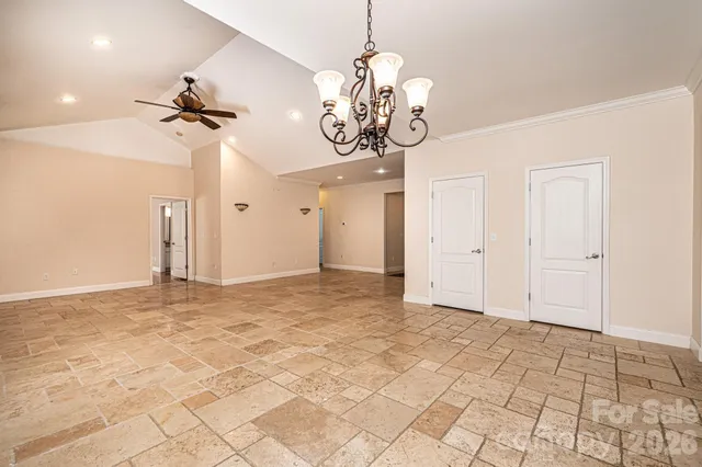 a view of a chandelier fan and wooden floor