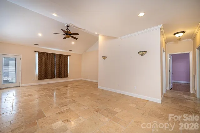 a view of an empty room with a ceiling fan