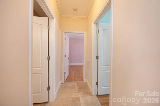 a view of a hallway with wooden floor and entryway