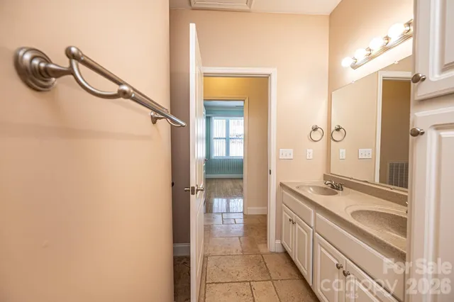 a bathroom with a granite countertop sink a mirror and a shower