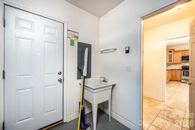 a view of a hallway with bathroom and wooden floor