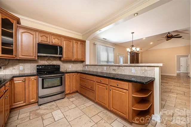 a kitchen with stainless steel appliances granite countertop a stove and a sink