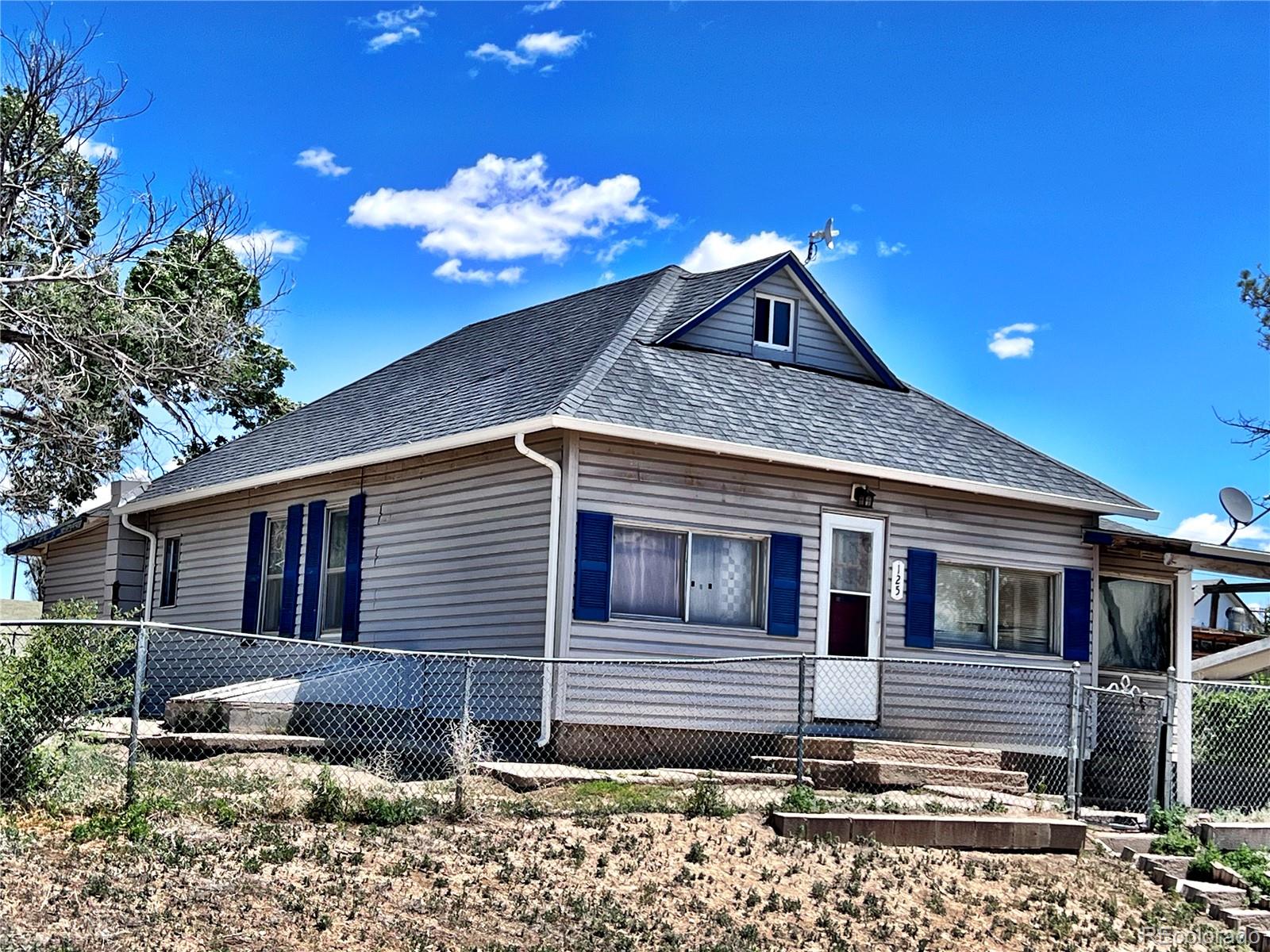125 Seventh Street Hugo, CO 80821 - Photo 1 of 24 a house view with a backyard space