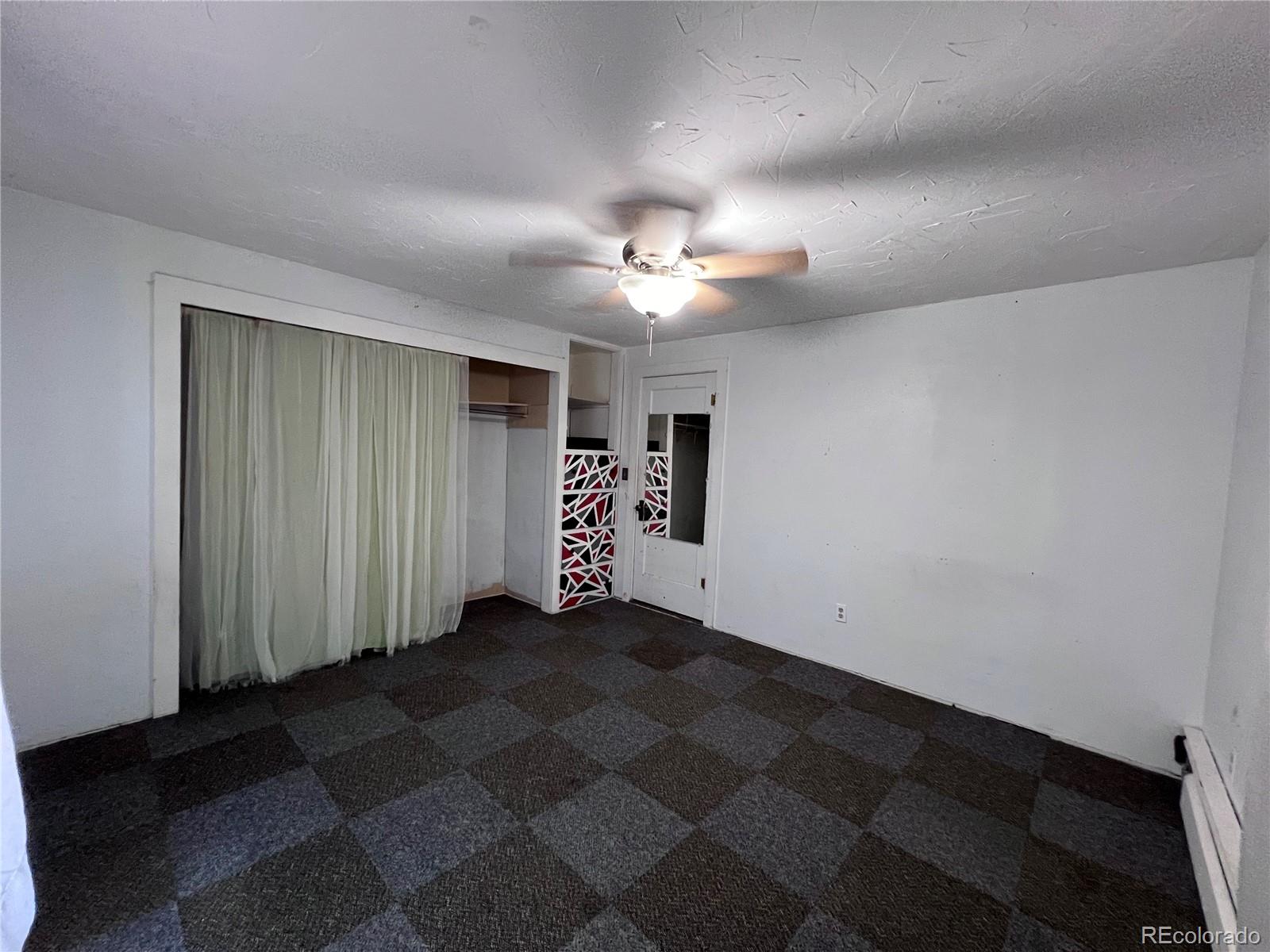 125 Seventh Street Hugo, CO 80821 - Photo 11 of 24 a view of a livingroom with a ceiling fan and window
