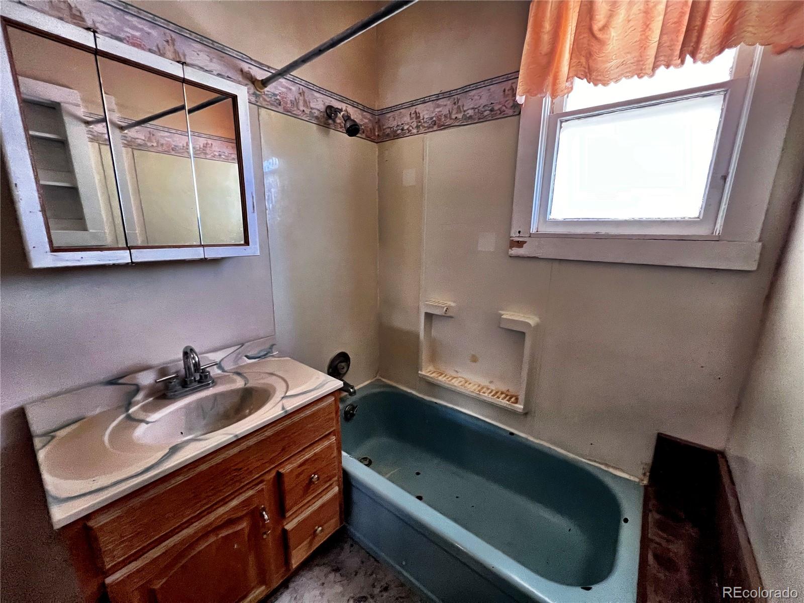 125 Seventh Street Hugo, CO 80821 - Photo 13 of 24 a bathroom with a sink and a bathtub