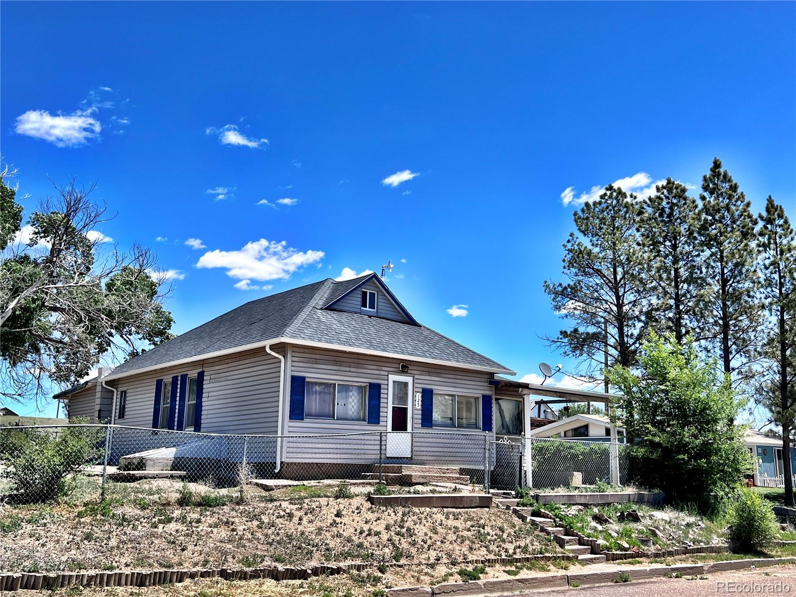 125 Seventh Street Hugo, CO 80821 - Photo 2 of 24 a front view of a house with garden