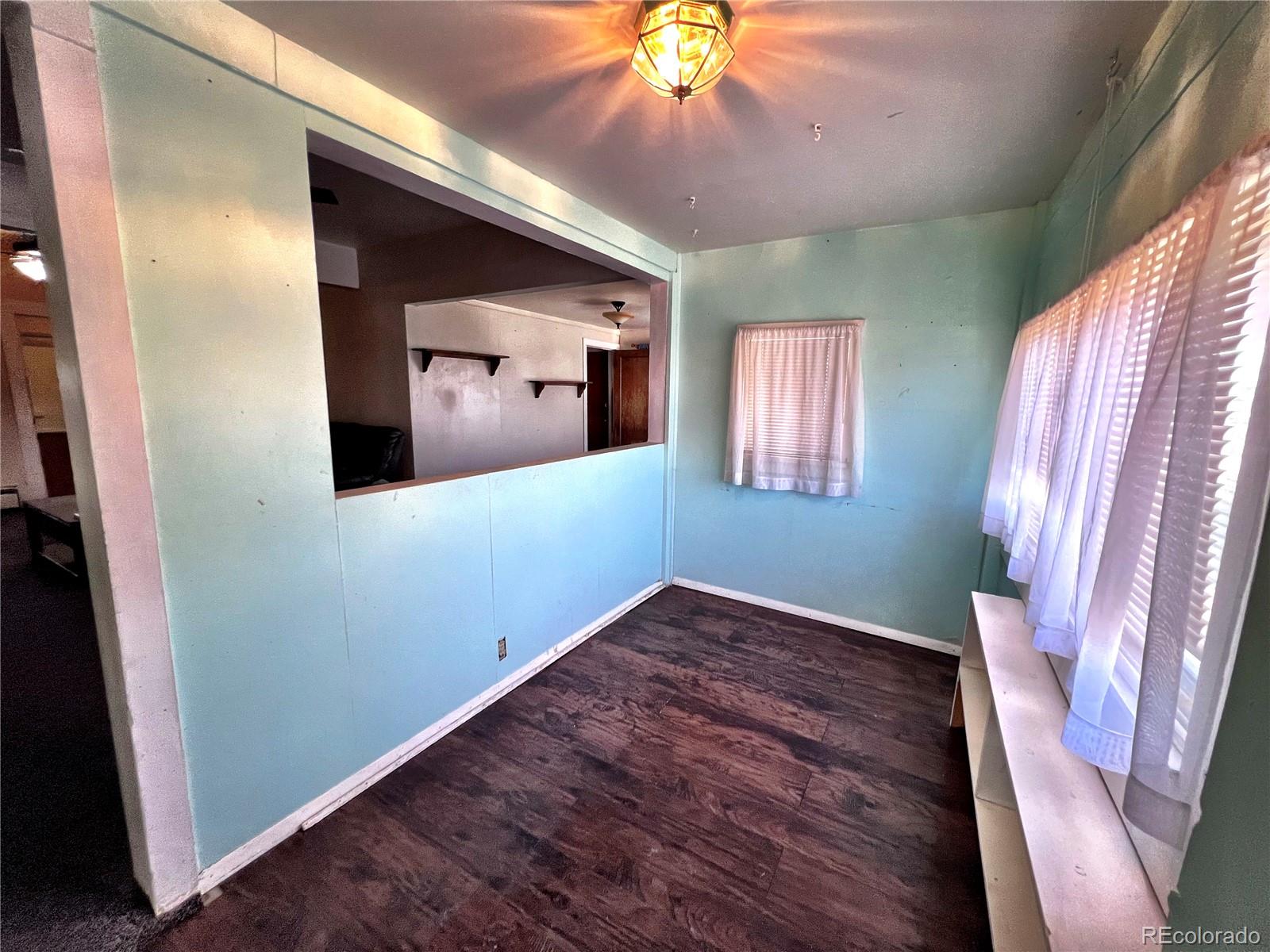 125 Seventh Street Hugo, CO 80821 - Photo 3 of 24 a view of a hallway with wooden floor and a cabinet