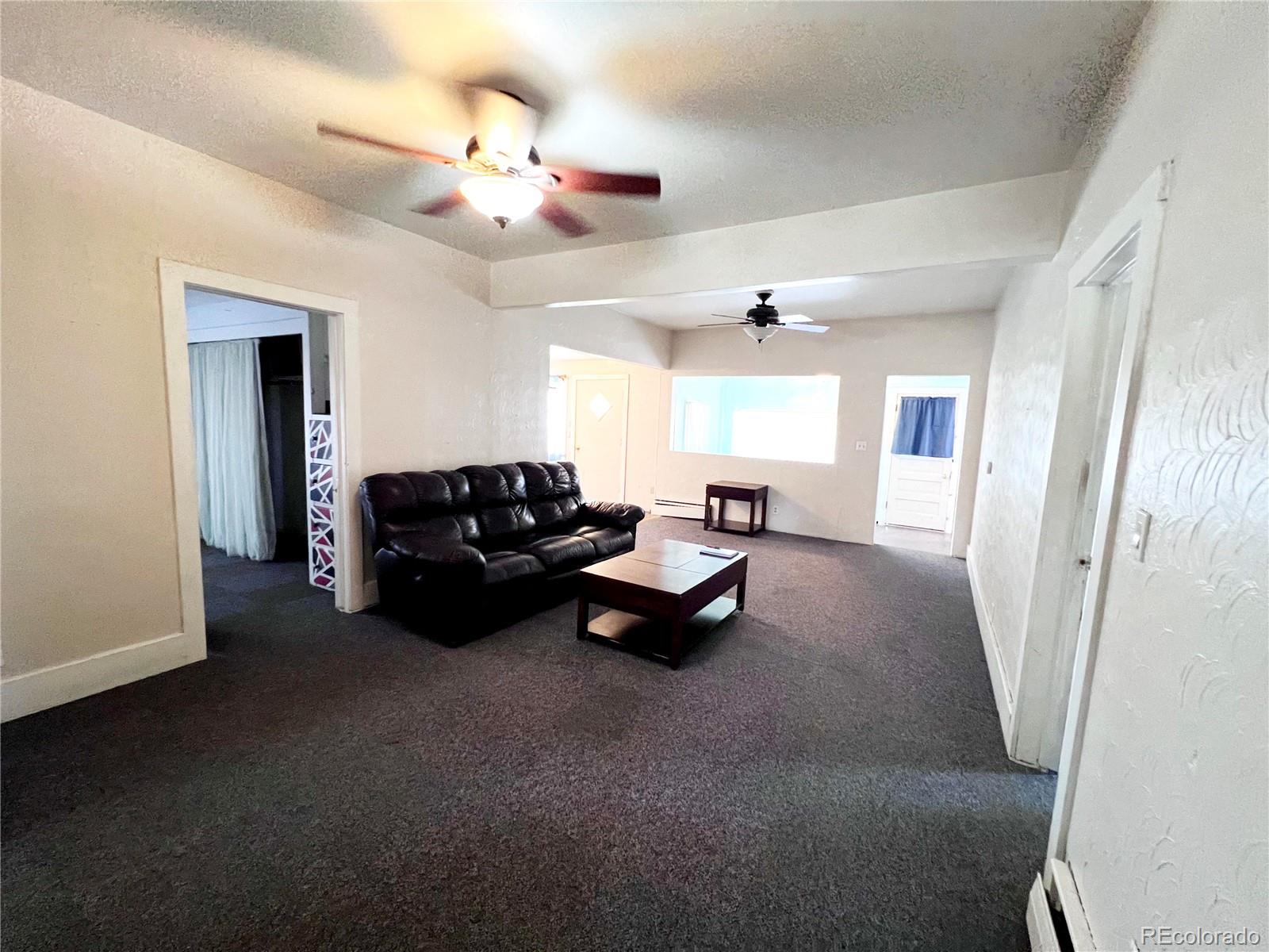 125 Seventh Street Hugo, CO 80821 - Photo 5 of 24 a living room with furniture and a chandelier