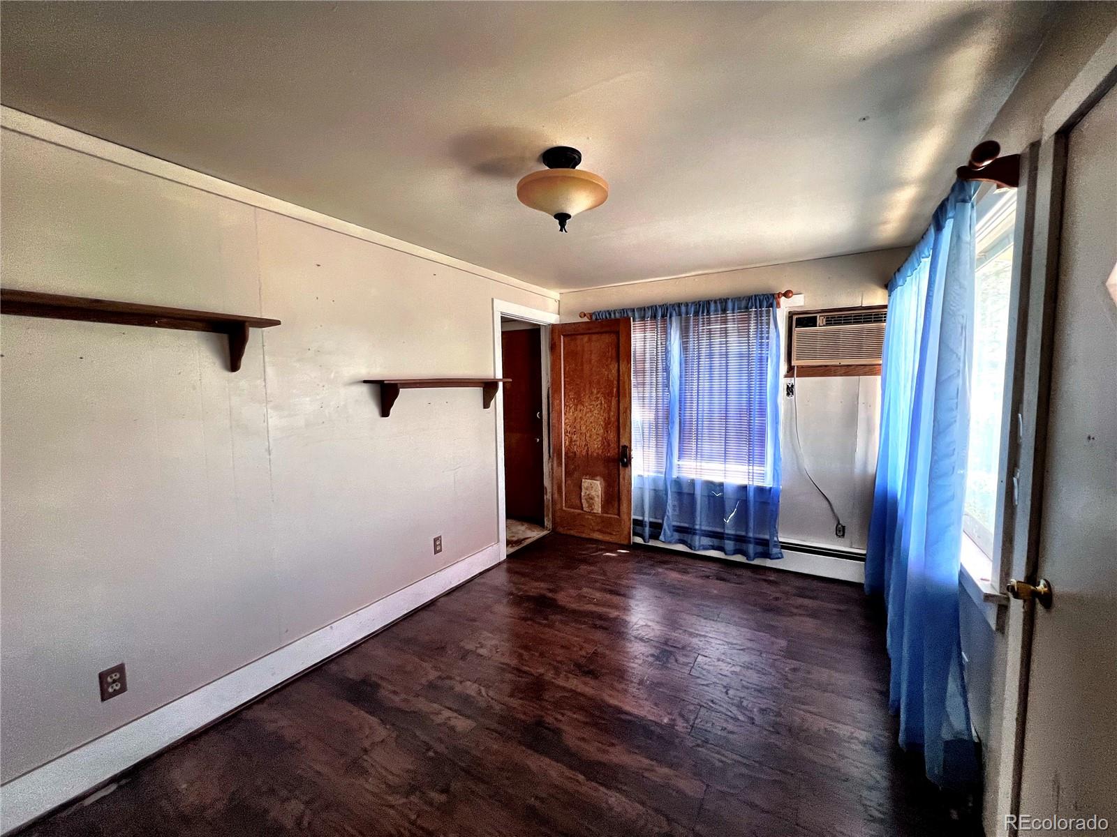 125 Seventh Street Hugo, CO 80821 - Photo 6 of 24 wooden floor in an empty room with a window