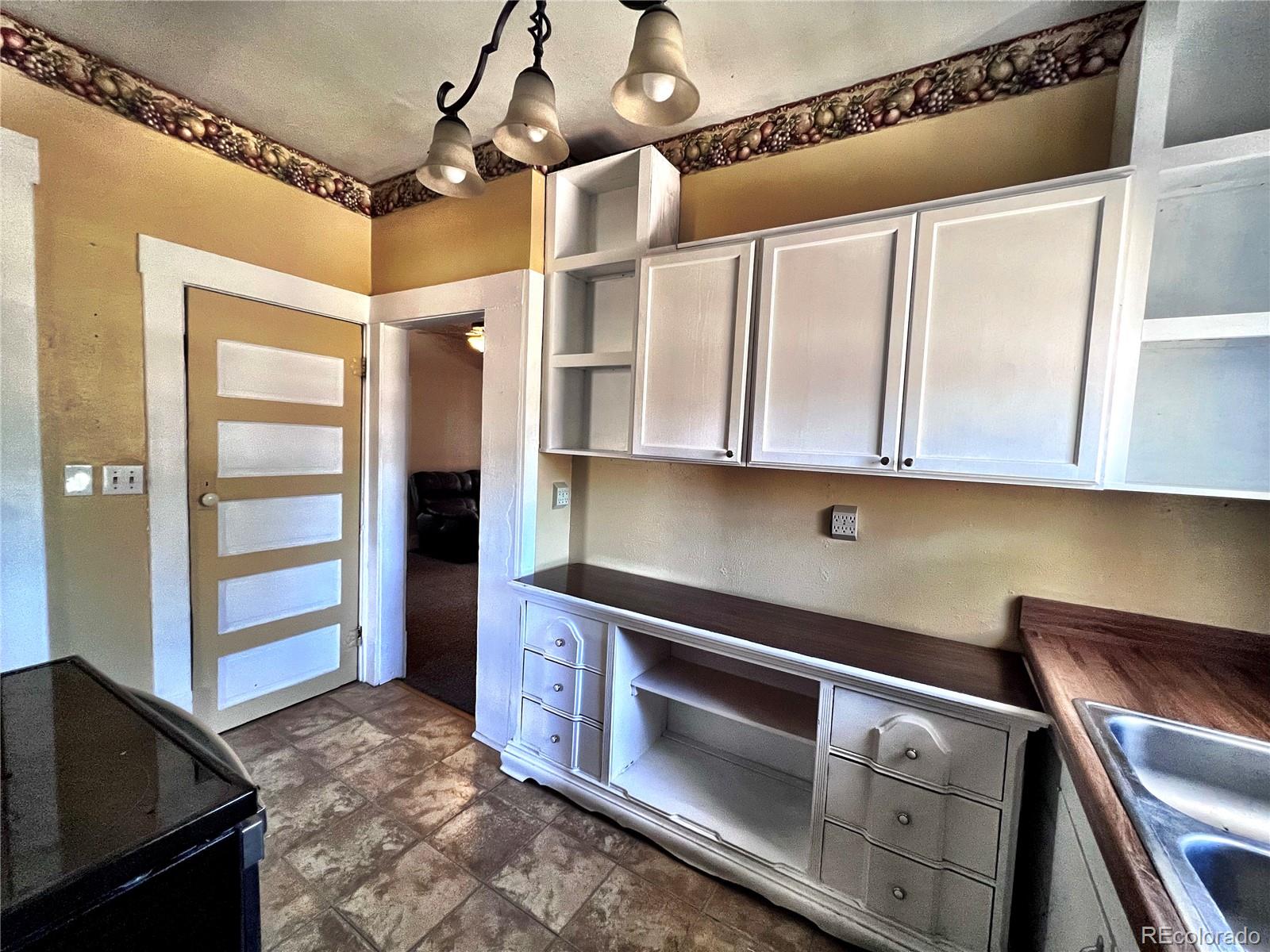 125 Seventh Street Hugo, CO 80821 - Photo 7 of 24 a kitchen with stainless steel appliances granite countertop a refrigerator and a stove