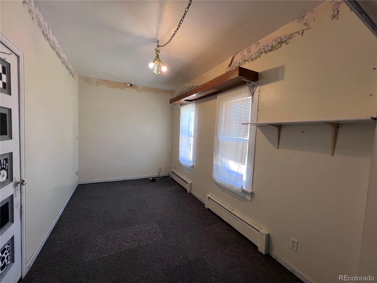 125 Seventh Street Hugo, CO 80821 - Photo 10 of 24 a view of a livingroom with an empty space and a window