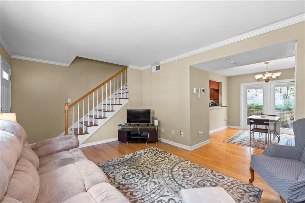 6940 Roswell Road, Unit 11B Atlanta, GA 30328 - Photo 1 of 1 a living room with furniture rug and a dining table