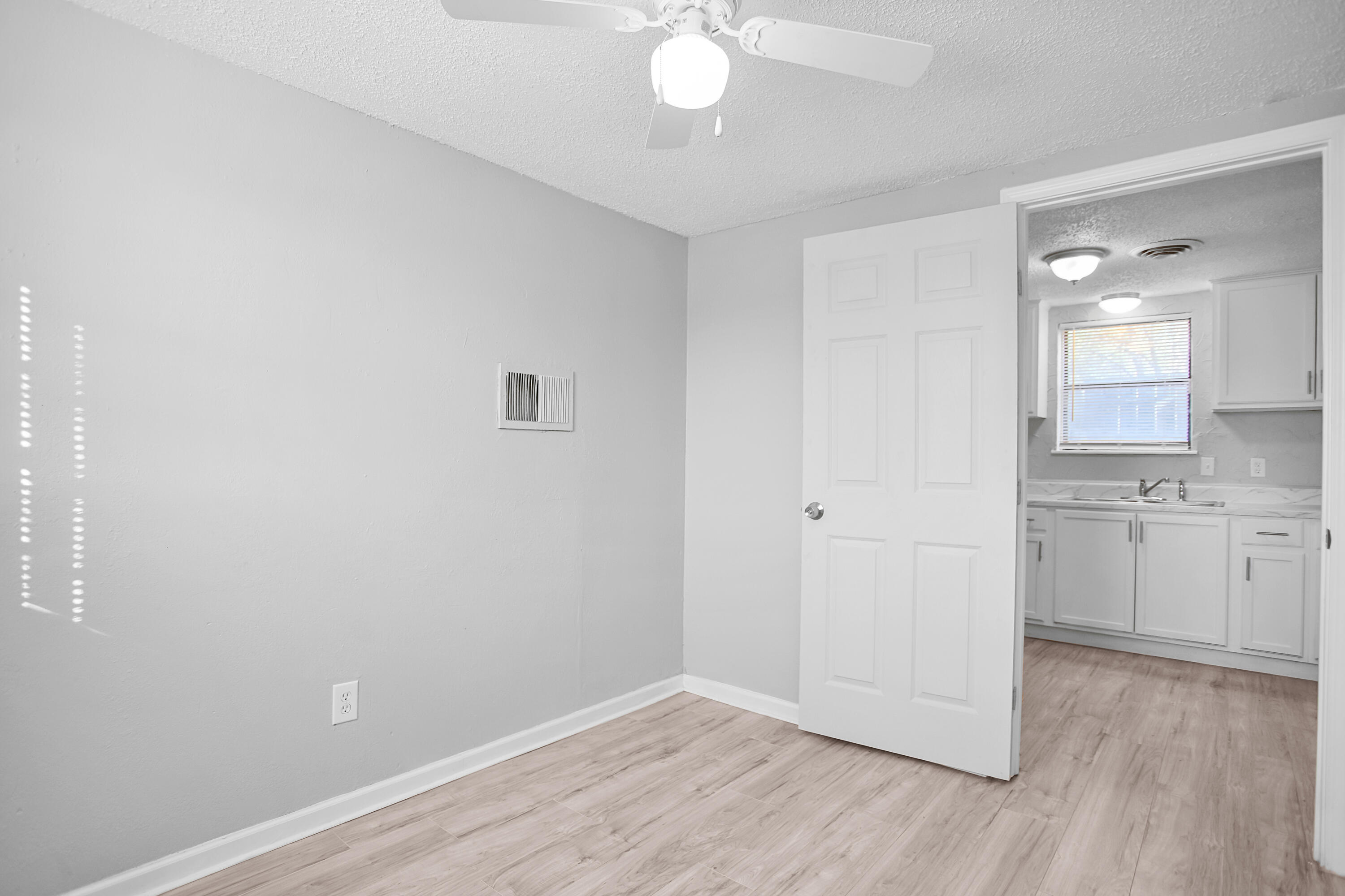 2430 31st Street Lubbock, TX 79411 - Photo 12 of 46 a view of a kitchen with wooden floor and a sink