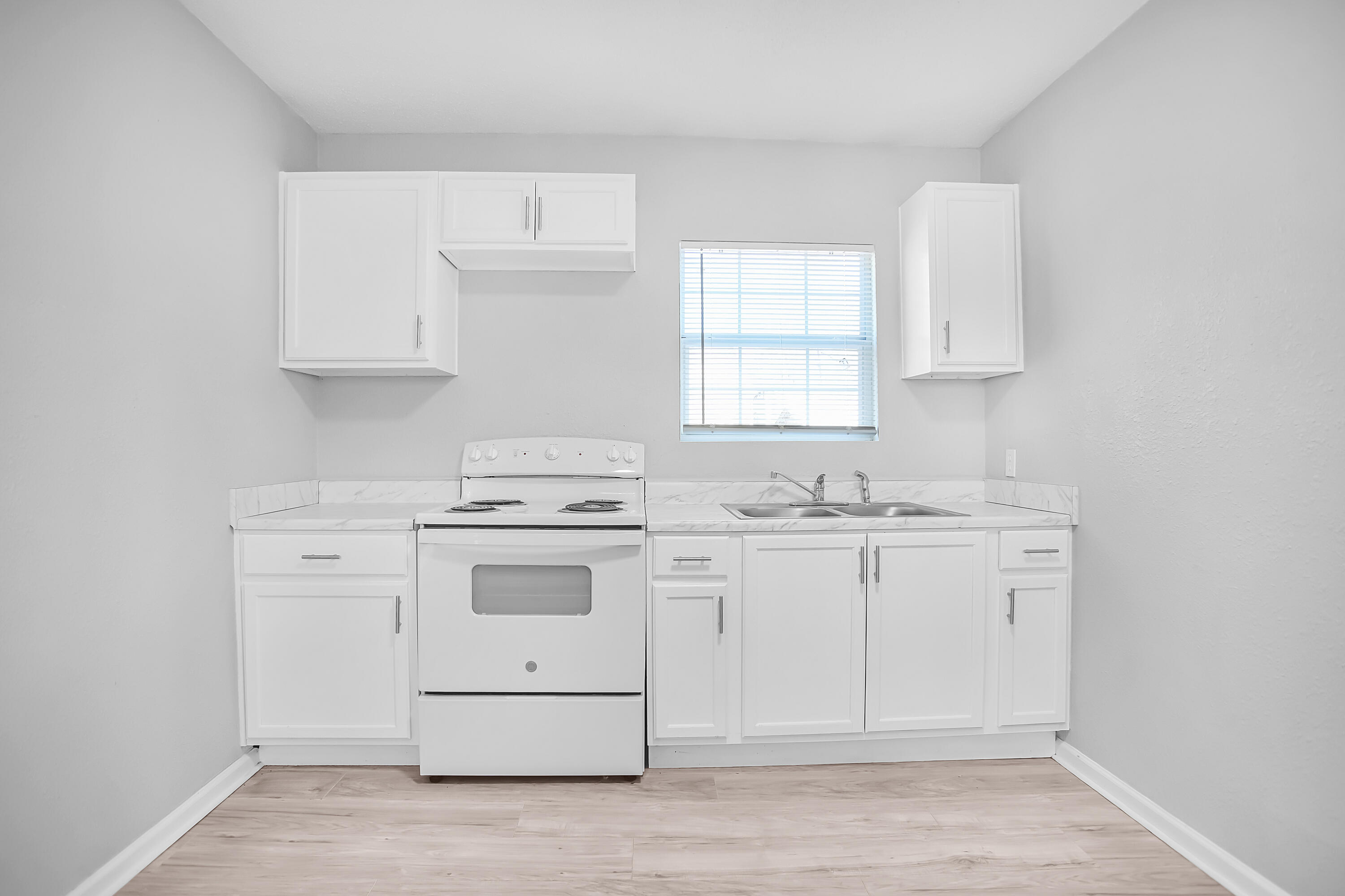 2430 31st Street Lubbock, TX 79411 - Photo 13 of 46 a kitchen with white cabinets appliances and a window