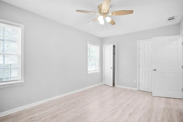 front view of a house with a yard and an trees