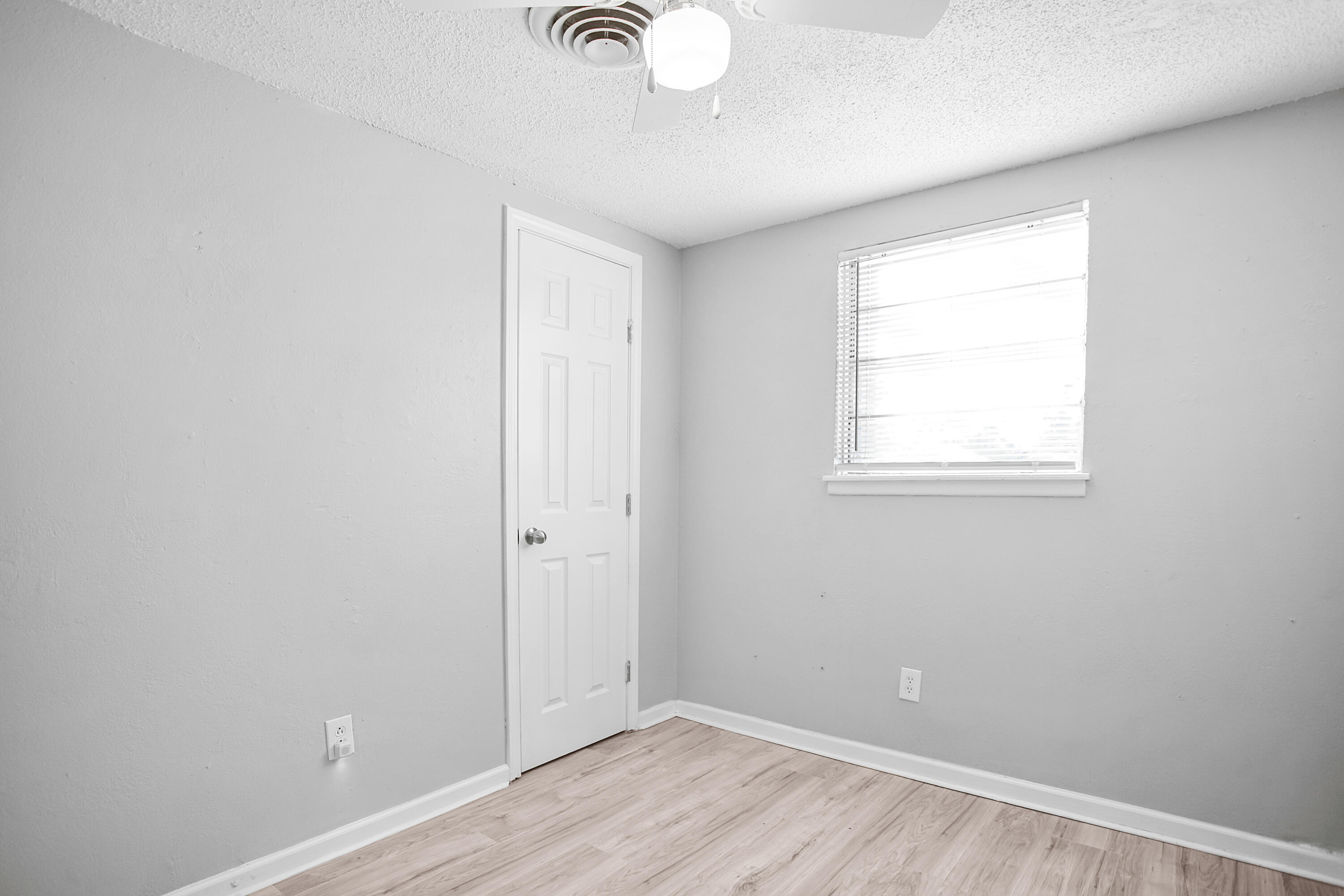 2430 31st Street Lubbock, TX 79411 - Photo 23 of 46 an empty room with wooden floor and windows