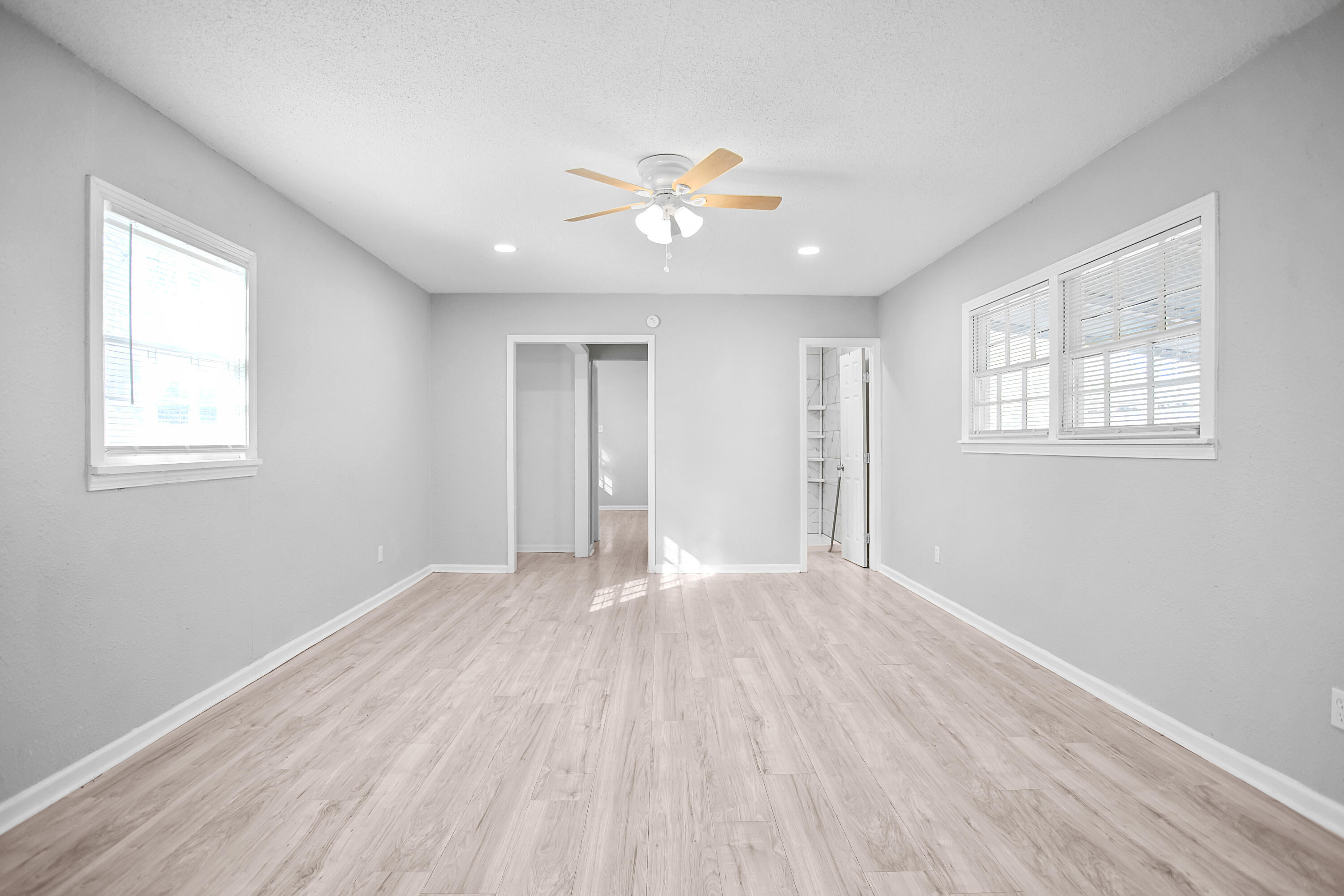 2430 31st Street Lubbock, TX 79411 - Photo 25 of 46 a view of an empty room with wooden floor and a window