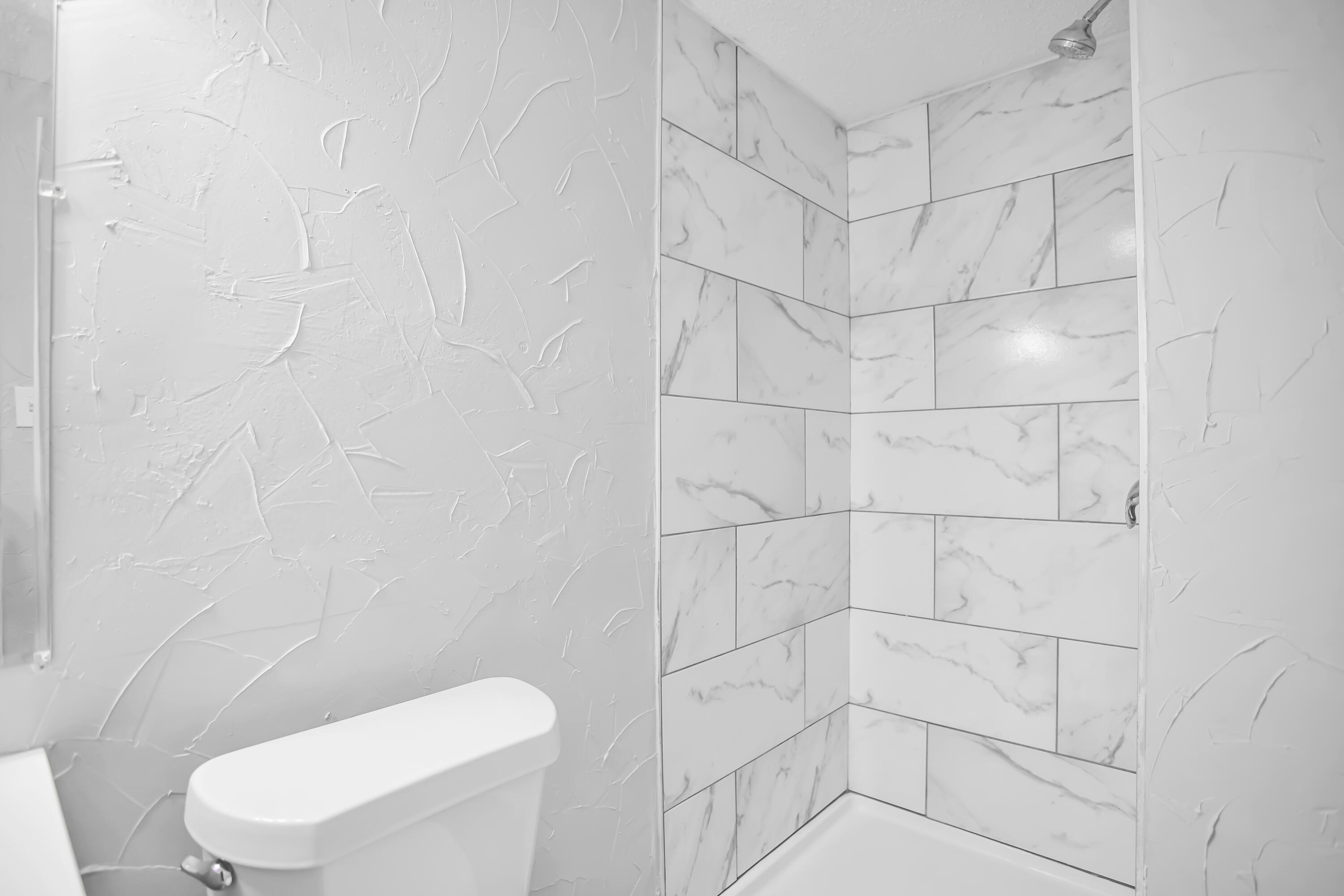 2430 31st Street Lubbock, TX 79411 - Photo 29 of 46 a white toilet and shower in a bathroom