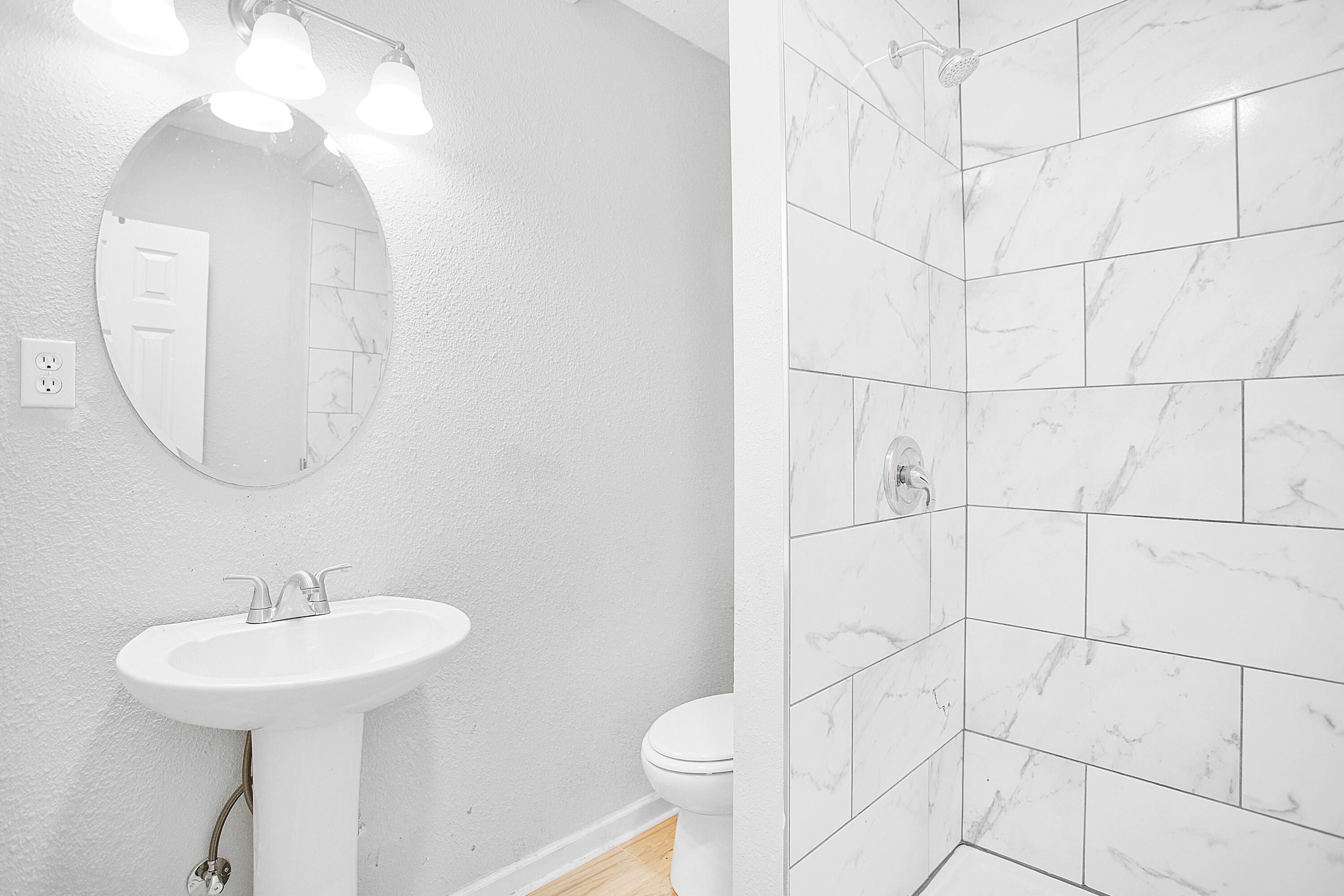 2430 31st Street Lubbock, TX 79411 - Photo 38 of 46 a bathroom with a sink toilet and a mirror
