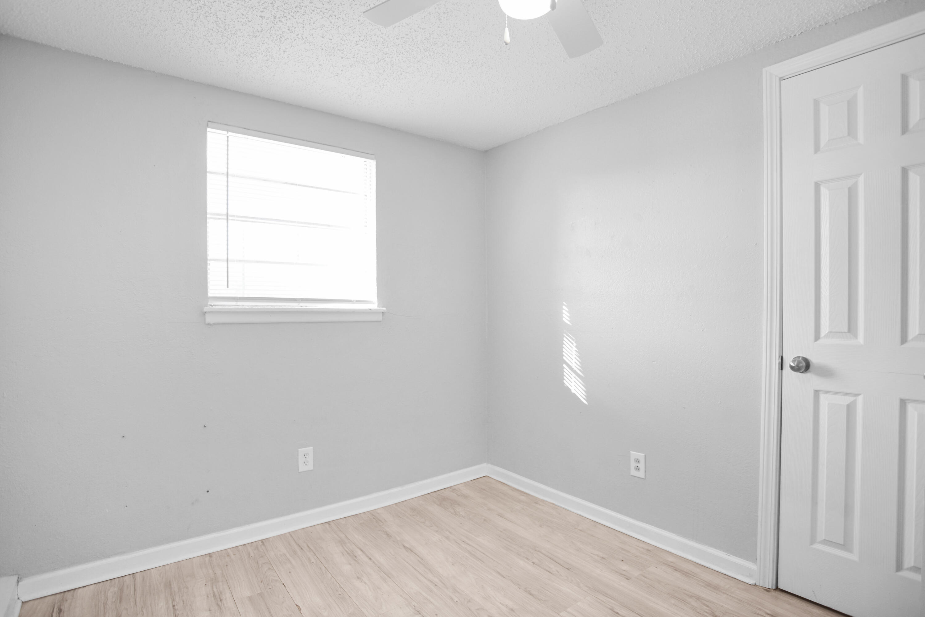 2430 31st Street Lubbock, TX 79411 - Photo 42 of 46 an empty room with wooden floor and windows