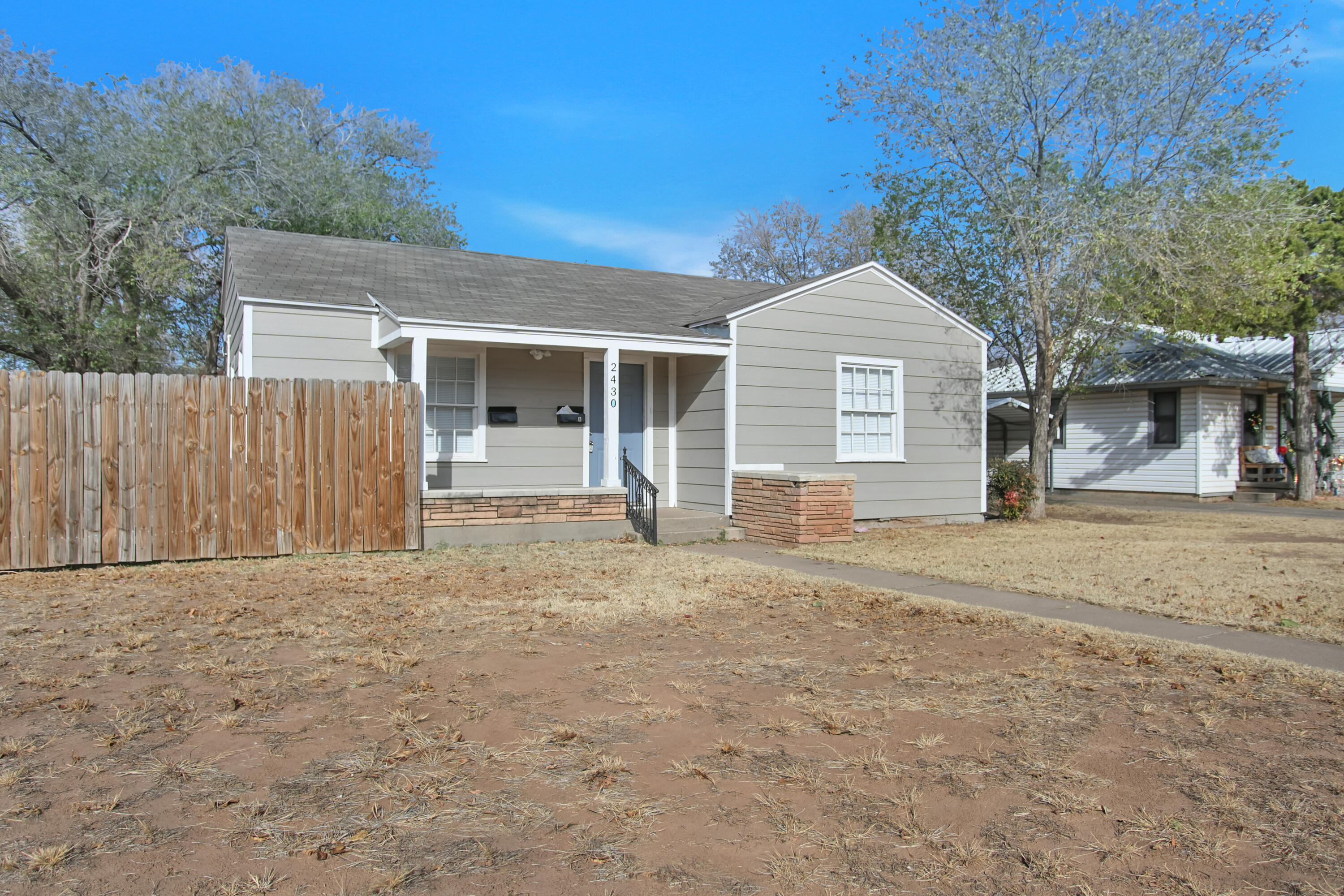 2430 31st Street Lubbock, TX 79411 - Photo 43 of 46 front view of a house with a yard and an trees