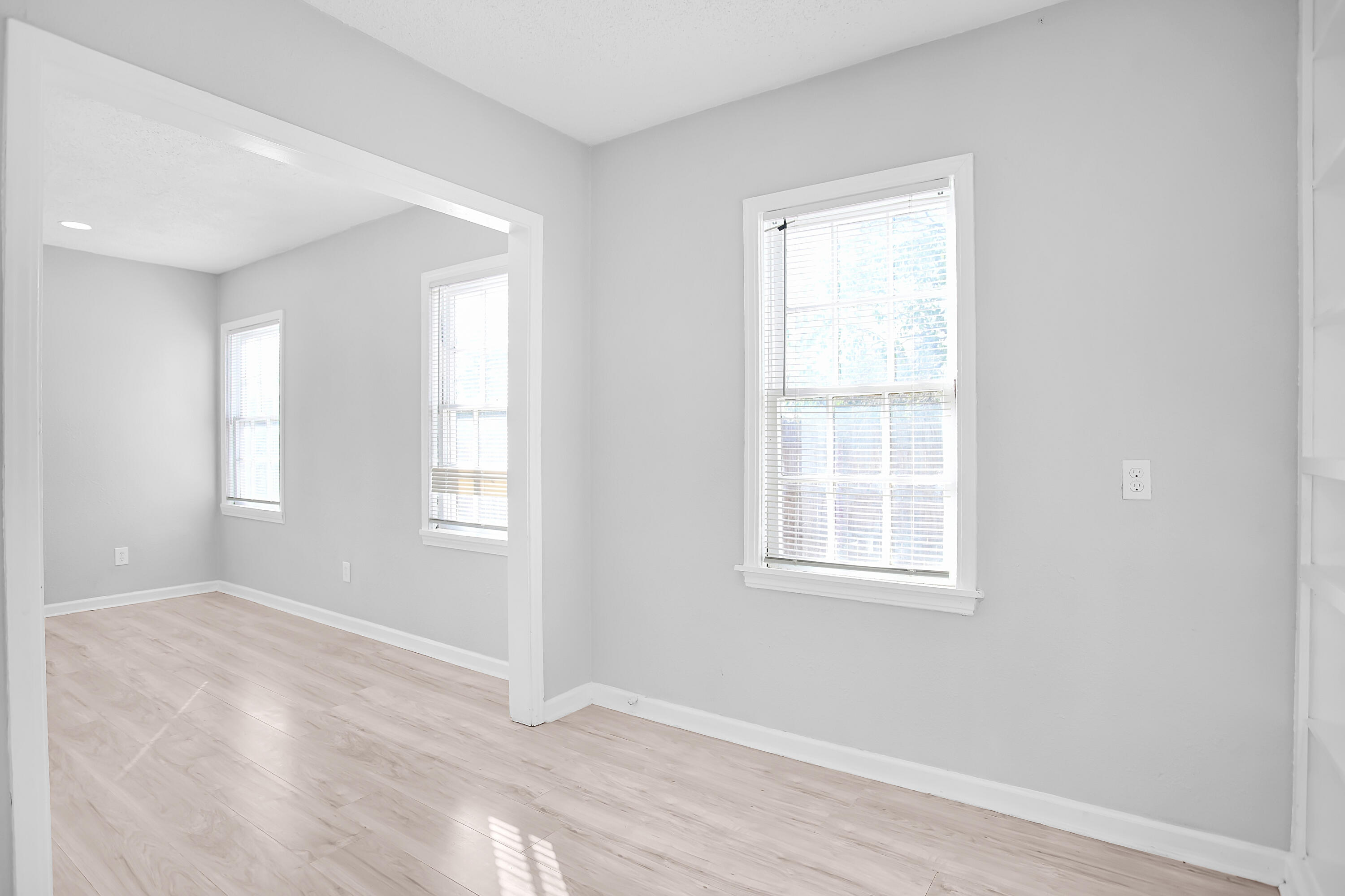 2430 31st Street Lubbock, TX 79411 - Photo 5 of 46 an empty room with wooden floor and windows