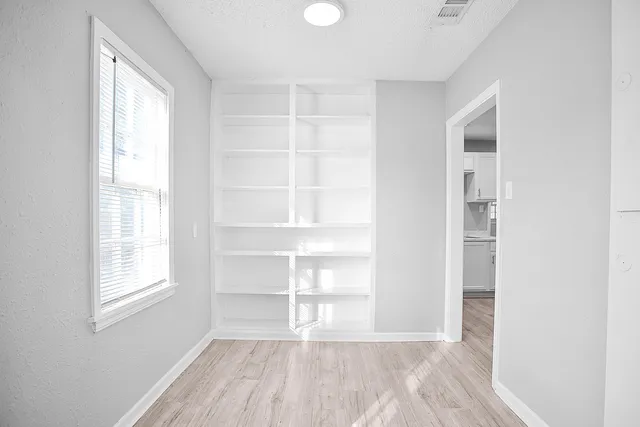 a view of a kitchen with wooden floor and a sink
