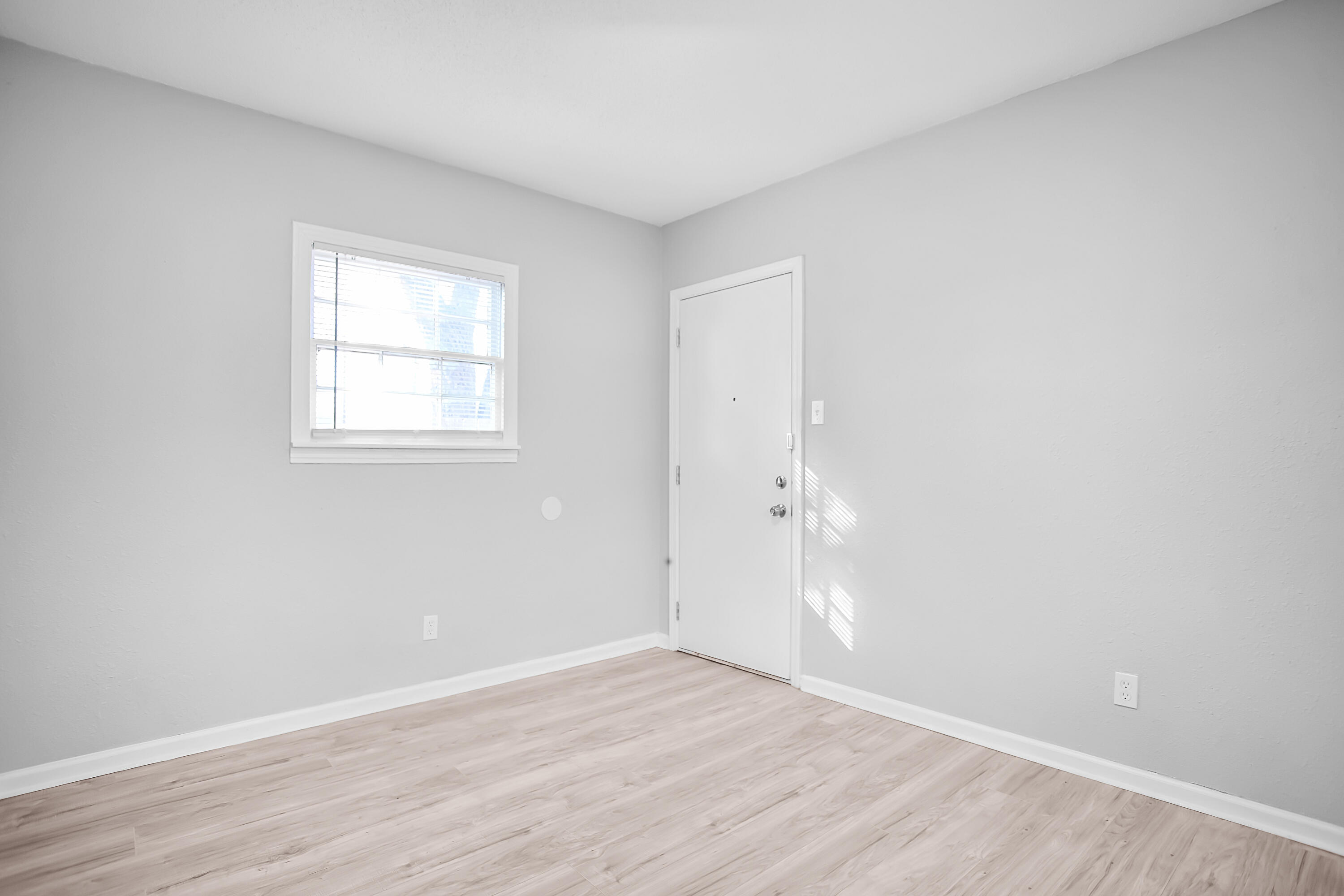 2430 31st Street Lubbock, TX 79411 - Photo 9 of 46 an empty room with wooden floor and window