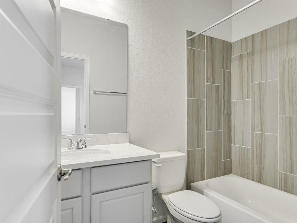 396 Cold Riv Run Kyle, TX 78640 - Photo 14 of 20 a bathroom with a sink a toilet and shower