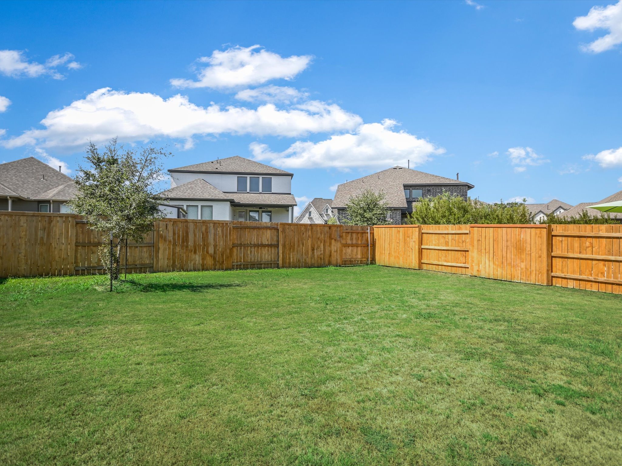 396 Cold Riv Run Kyle, TX 78640 - Photo 20 of 20 a view of a garden with a house in the background