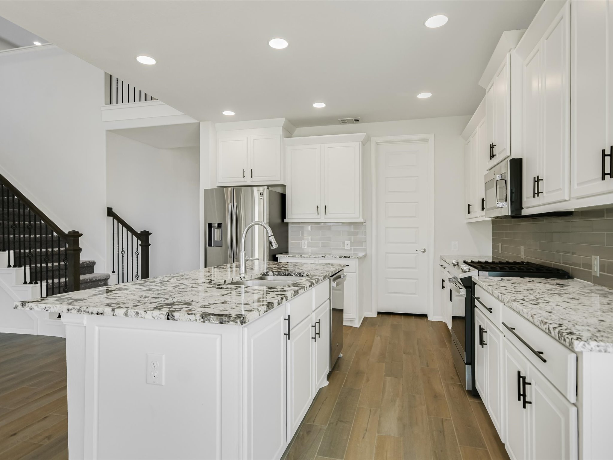396 Cold Riv Run Kyle, TX 78640 - Photo 6 of 20 a kitchen with stainless steel appliances granite countertop a sink stove and refrigerator
