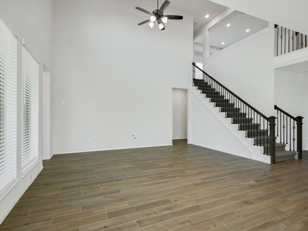 396 Cold Riv Run Kyle, TX 78640 - Photo 7 of 20 wooden floor in an empty room with a window