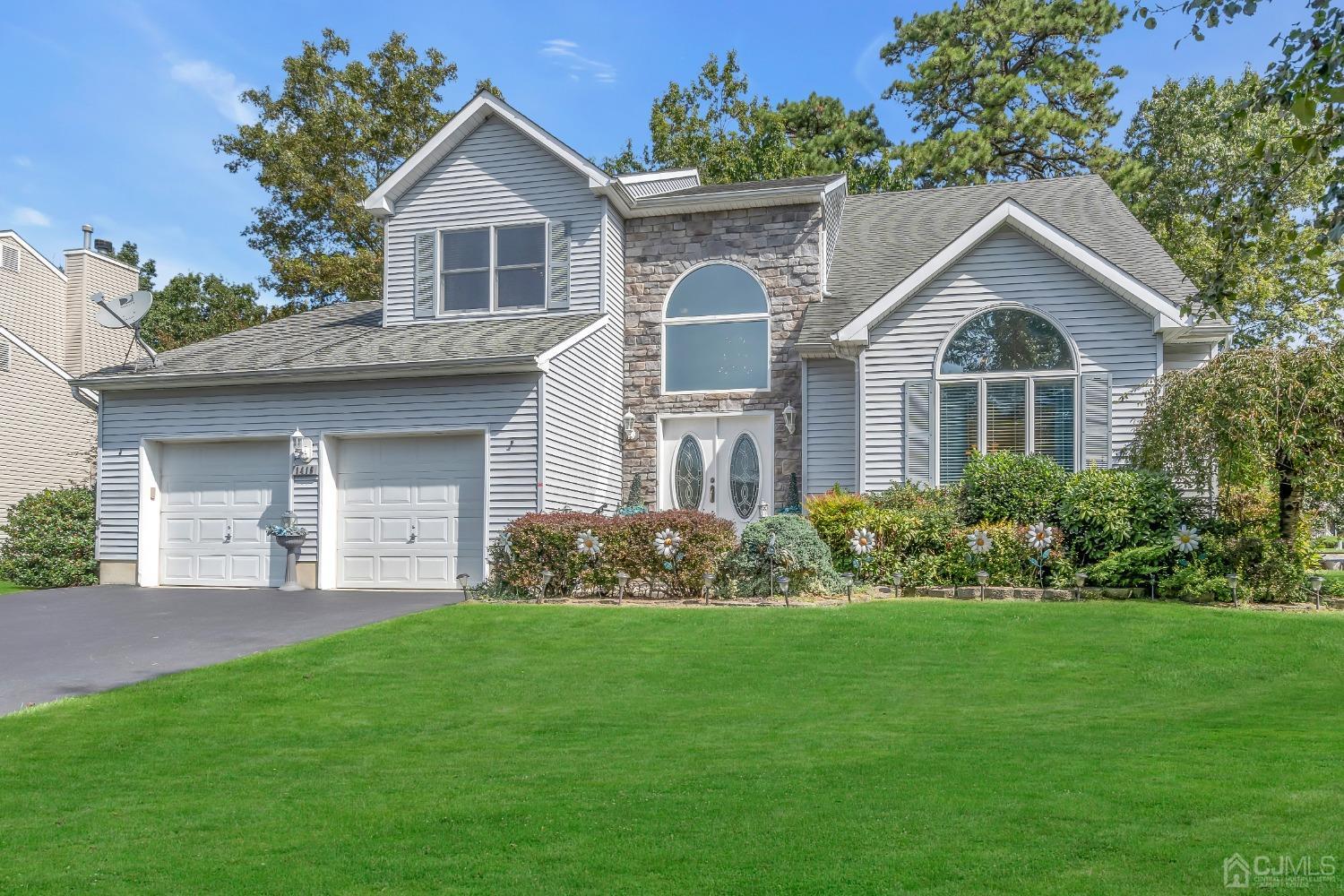 1416 Princess Avenue Brick, NJ 08724 - Photo 1 of 39 a front view of a house with a garden and plants